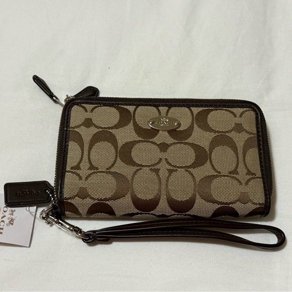 Coach Handbags - Coach Tan and Brown Signature Wristlet with defects.